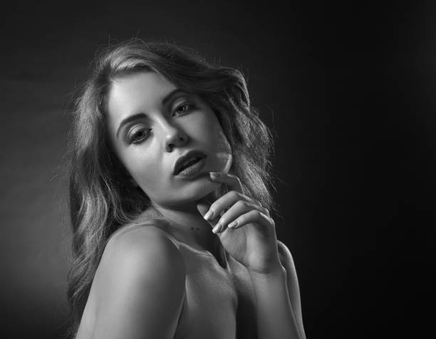 istock Attractive blonde woman on dark background . 847182870