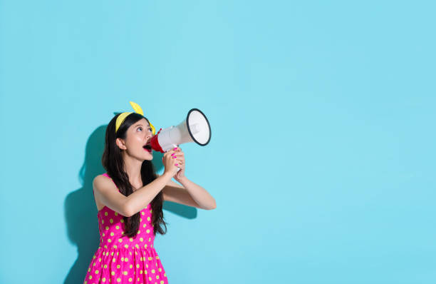 istock happy beautiful woman using megaphone speaking 847188020