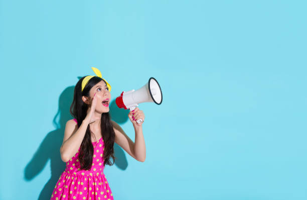istock young smiling woman holding loudspeaker device 847188034