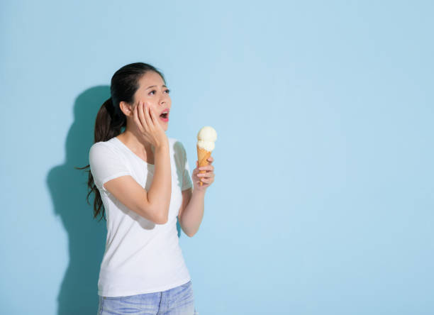 istock cute young female student eating ice cream 847188370