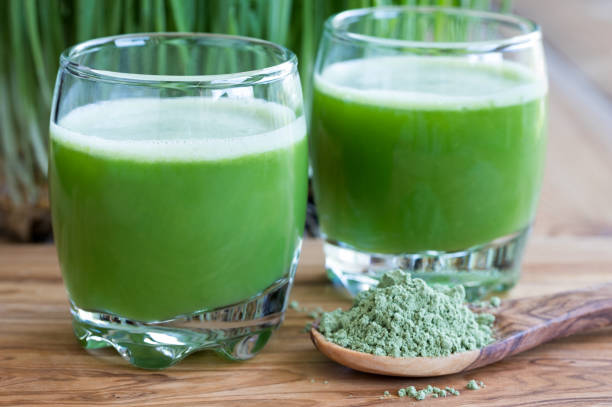 istock Two shots of fresh barley grass juic 847190952