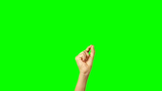 Person making hand gesture against green screen background
