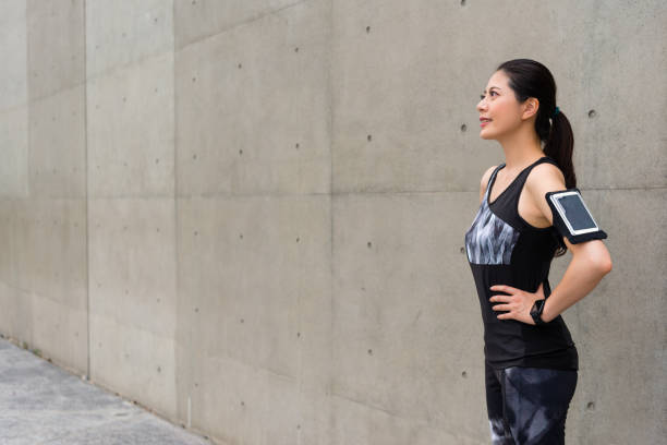 istock woman runner confident standing on gray wall 847192614