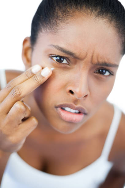 istock Unsmiling woman putting moisturizer on her face 847192654