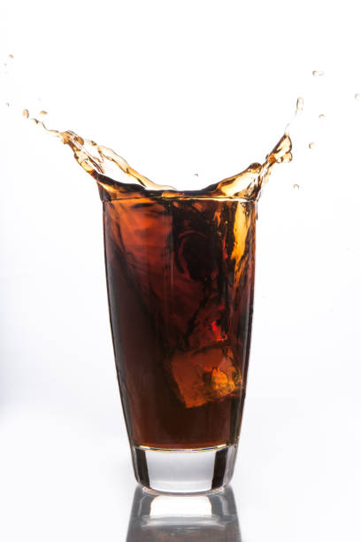 istock Ice cube falling into glass of soda 847197118