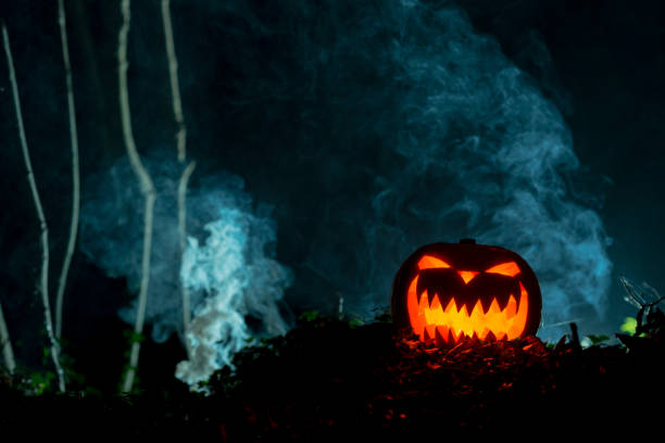istock Glowing Halloween Pumpkin in Hazy Scenery with Copy Space 847198766