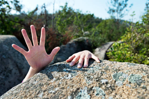 istock Woman hand for help on the rock 847199340