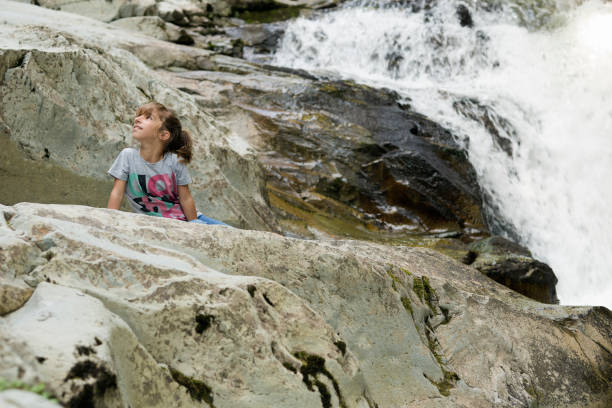 istock Girl next to the Waterfall 847199694