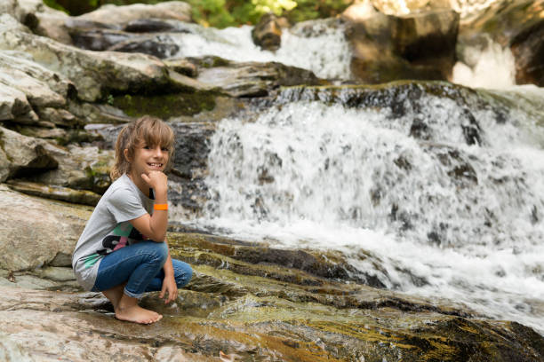 istock Girl next to the Waterfall 847201834