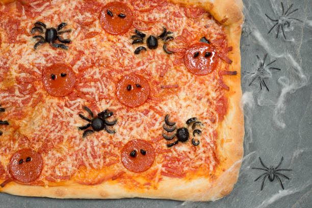 istock Halloween-Themed Pizza Beside Creepy Spiders on Web 847202262