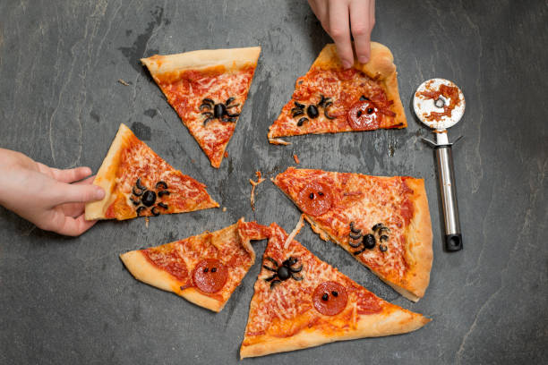 istock Two Hands Taking Slices of Halloween Pizza 847202320