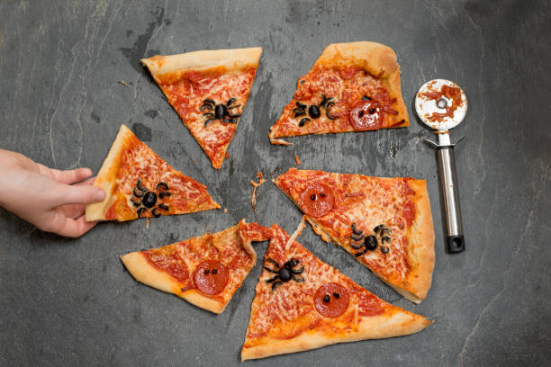 istock Hand Taking a Slice of Halloween Pizza 847202342