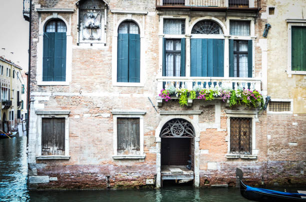 Ancient wooden entrance doors outside in Venice canal house