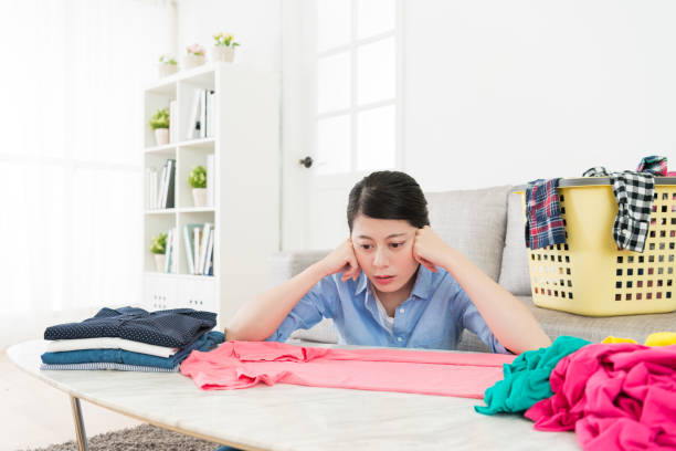 istock pretty woman looking at tshirt feeling bored 847203204
