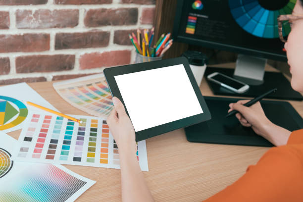 istock beautiful female designer holding mobile computer 847206688
