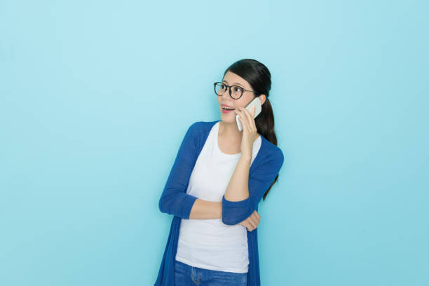 istock happy beautiful woman standing in blue background 847208476