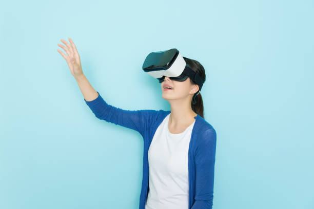 istock happy pretty woman wearing VR device headset 847212848