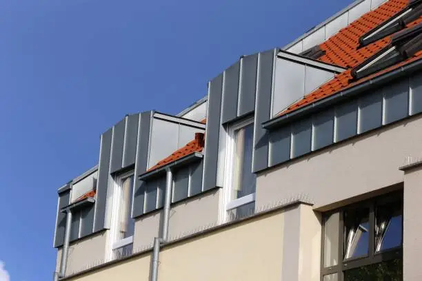 Dormer with stainless steel cladding, gutter and gutter pipe