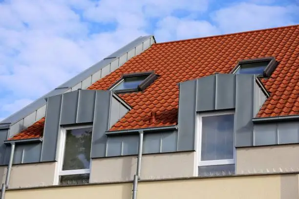 Dormer with stainless steel cladding, gutter and gutter pipe