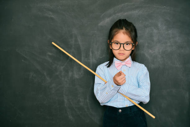 istock beautiful little teacher pointing someone rebukes 847213842