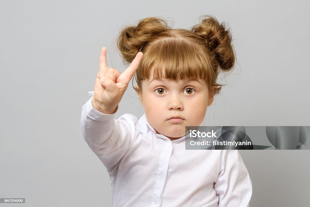 Retrato da menina fazendo sinal de rock isolado - Foto de stock de Criança royalty-free