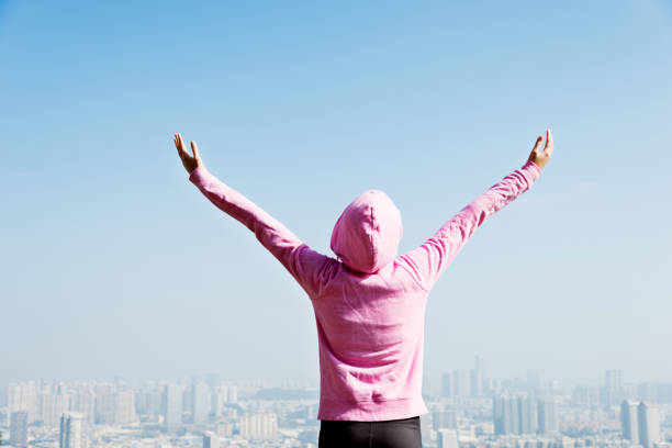 istock Young woman open arms on mountain peak 847214310