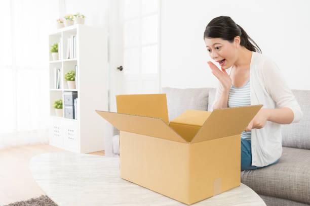 istock attractive woman received parcel from friend 847218072