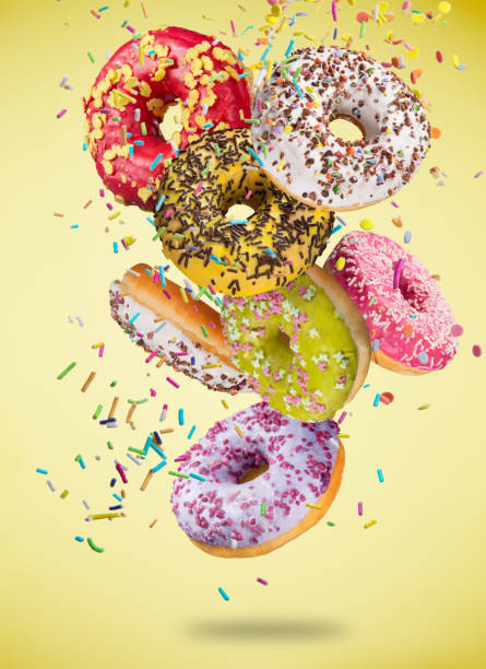 istock Tasty doughnuts in motion falling on pastel blue background 847218898