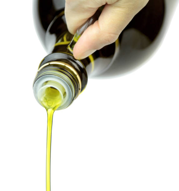 istock Pouring extra virgin olive oil from glass bottle 847222772