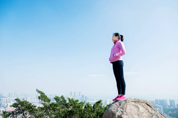 istock Woman standing on the mountain peak rock 847226114