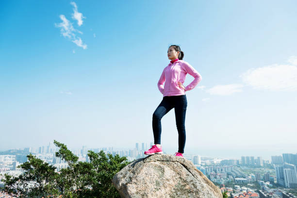 istock Woman standing on the mountain peak rock 847226128