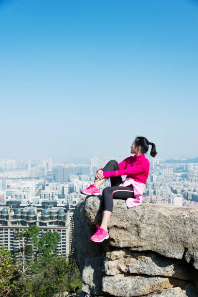 istock Woman sitting on mountain top enjoy the view 847226800