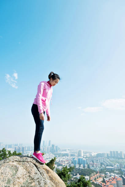 istock The desperate woman standing on the mountain peak 847227648