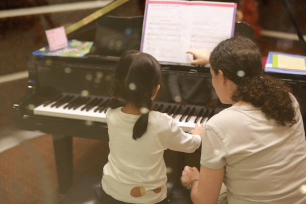 istock Child girl in piano class. 847227804