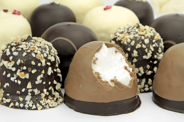 Chocolate coated cream puffs. Danish cuisine.