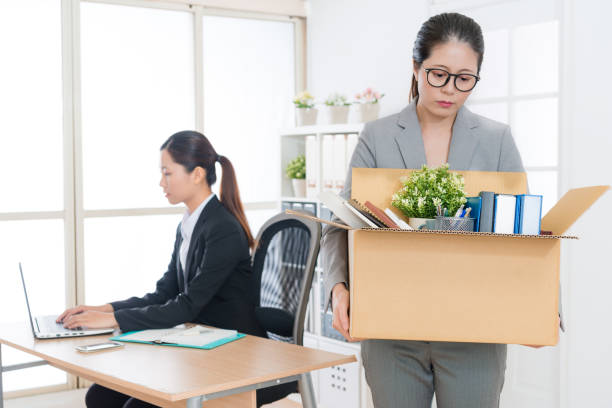 istock beautiful business woman is fired and holding box 847232914