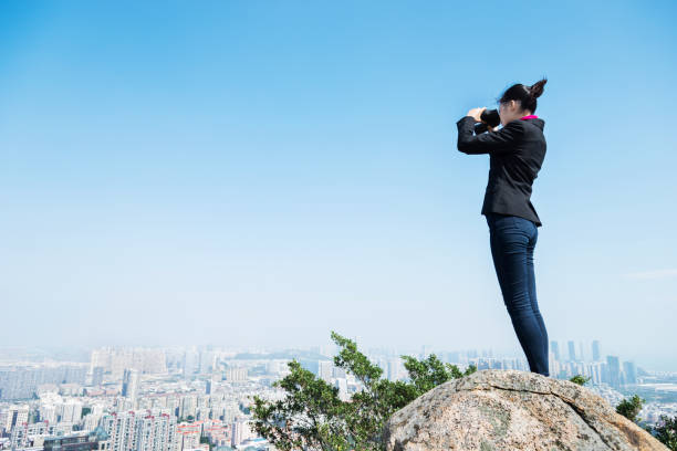 istock Businesswoman looking scenery with binocular 847233322