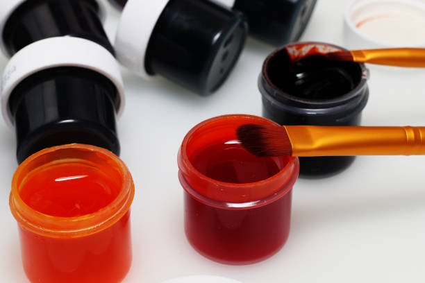 istock Artist's set: Brush, palette, open and closed jars with multi-colored gouache and covers from them on a white background 847233772