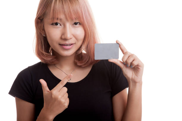 istock Young Asian woman point to a blank card. 847237370