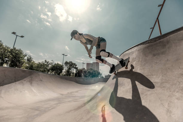 istock Young woman skateboarding in skatepark 847237890