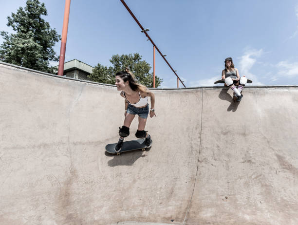 istock Two young women skateboarding 847237920
