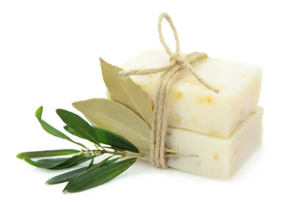 Natural herbal soaps with olive and bay leaf isolated on white background.