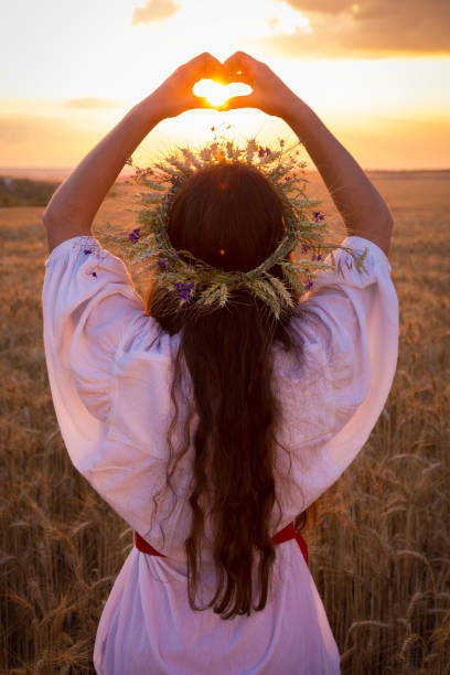 istock young girl on wheat field making heart symbol 847248884