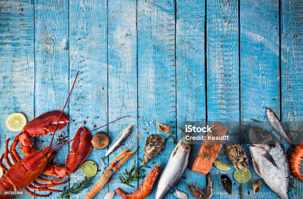 Fresh tasty seafood served on old wooden table Fresh tasty seafood served on old wooden table. Top view. Close-up. Seafood Stock Photo