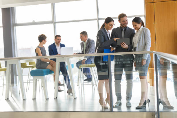 istock Young business people discussing business strategy using digital tablet 847253120