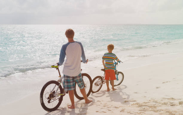 istock father with son and biking on tropical beach 847256146