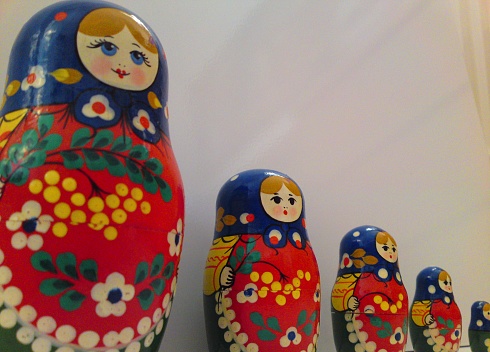 Five Russian Doll toys in a row, close-up.