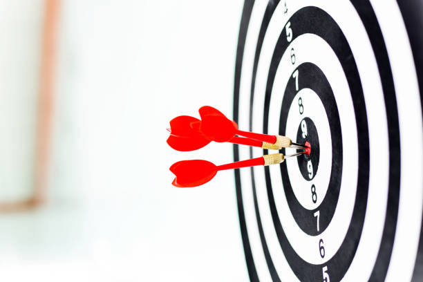 istock Three red darts arrows in the target center 847256870