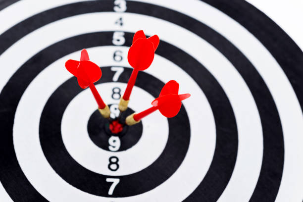 istock Three red darts arrows in the target center 847256958