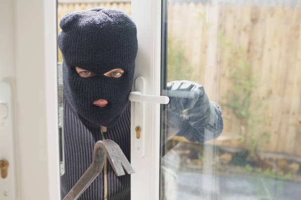 istock Burglar looking if someone is into the room 847260034
